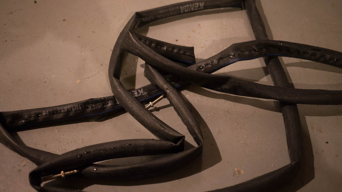 Two inner tubes on a basement floor.