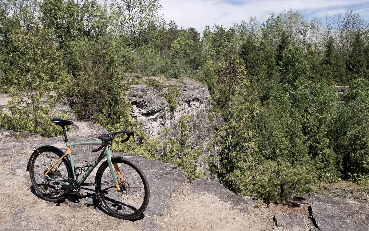 A lonely bike poses for a photo at the top of a cliff.