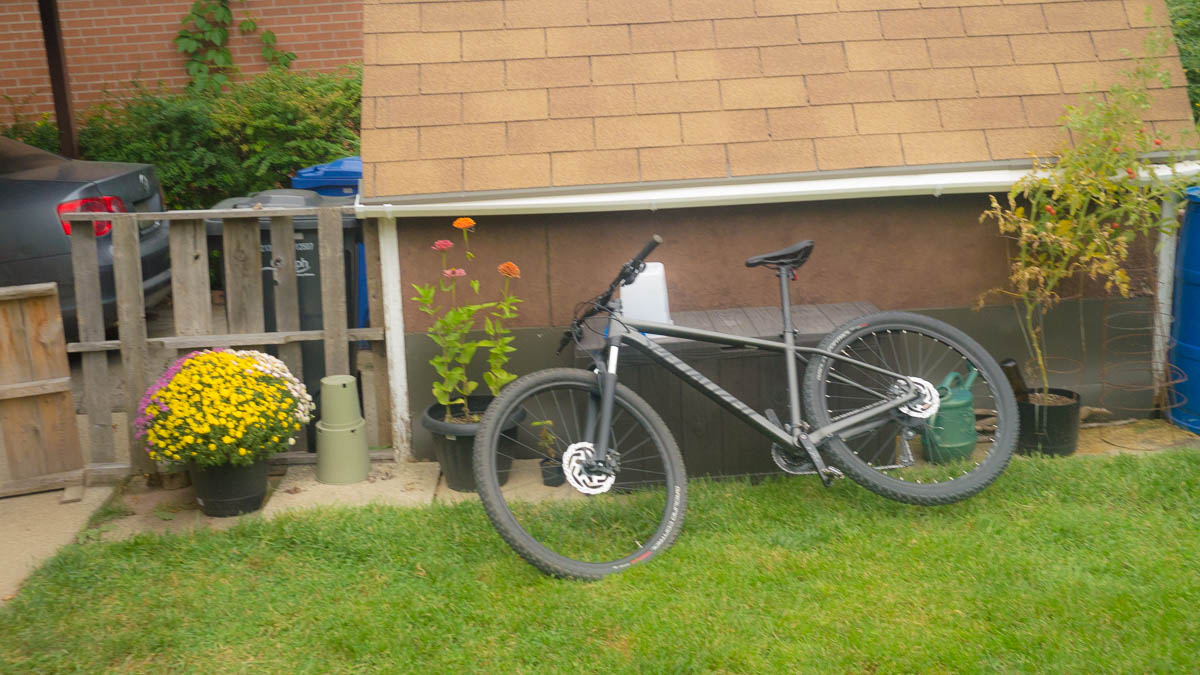 Bike dropped haphazardly on a pile of other crap.